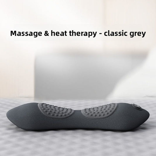 Gray massage and heat therapy pillow on a bed with a neutral background