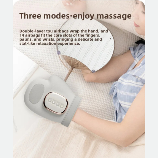 Luliqua HandRelief Pro three modes enjoy massage - woman in blue and white striped pajamas relaxing on white bed with gray hand massager, holding paper fan, gray massager with chrome control panel showing 4 buttons, double-layer TPU airbags wrap the hand with 14 airbags fitting core slots of fingers, palms and wrists for delicate and slot-like relaxation experience